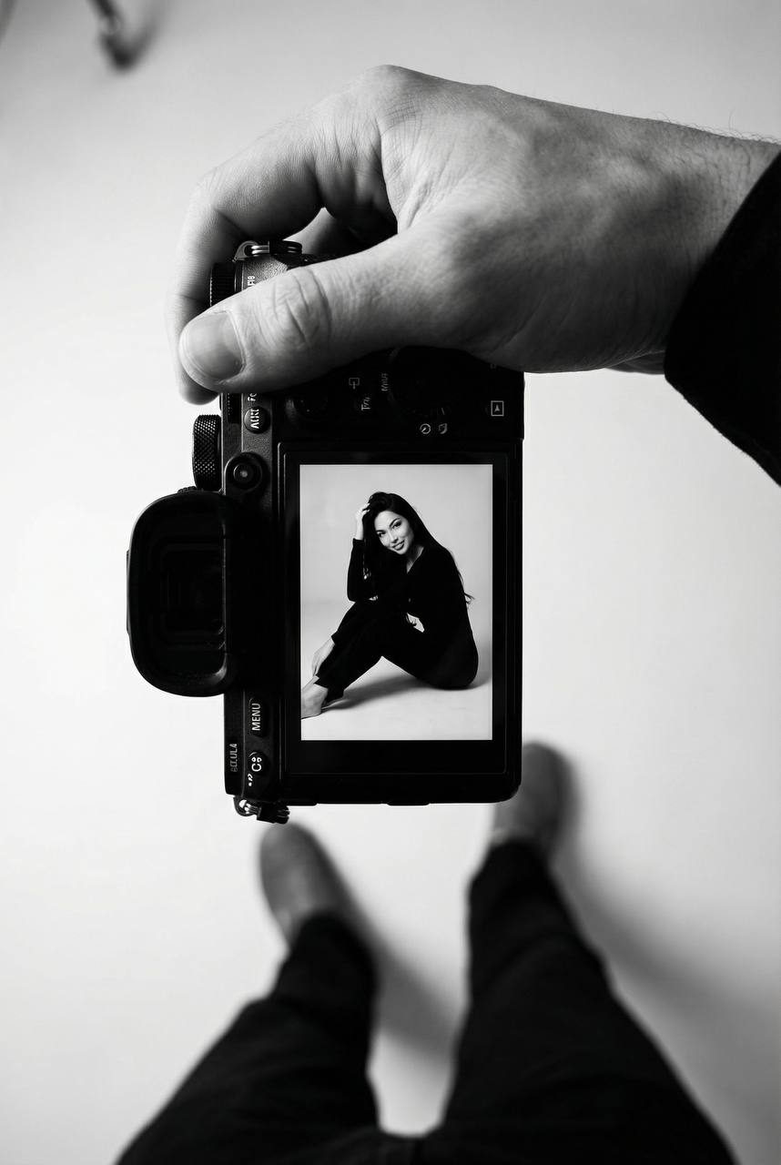 Photographer Looking Down At Camera Screen Monochrome Studio
