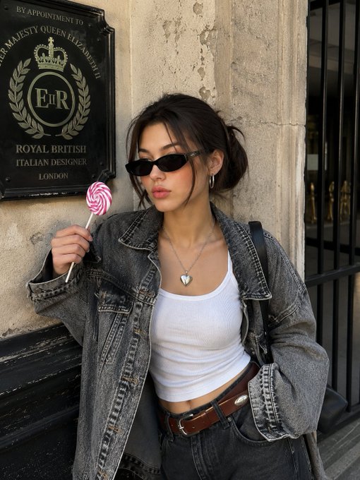 Leaning Against Stone Wall Holding Lollipop