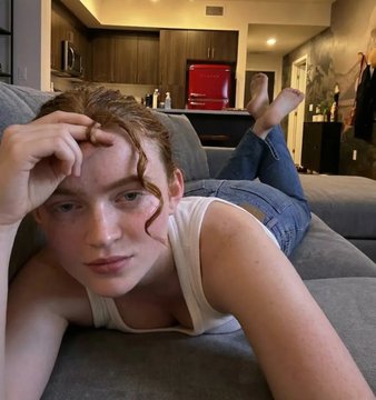 Sadie Sink Red Hair On Plush Sofa Apartment
