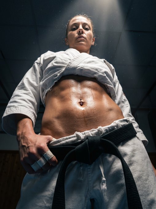 Martial Artist Low Angle Sweat Gi Dojo Light Shafts