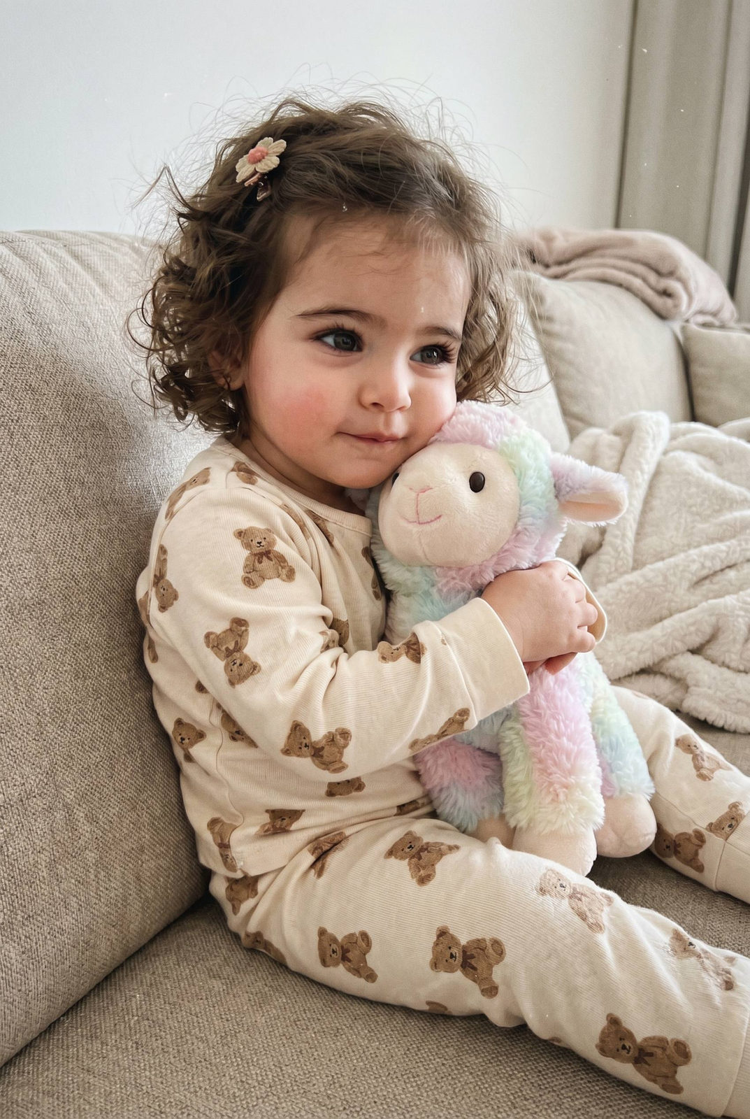 Toddler Girl Hugging Plush Lamb Cozy Pajamas Couch