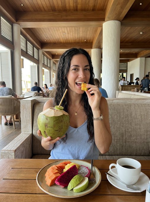 Tropical Restaurant Woman Eating Fruit Light Blue Top