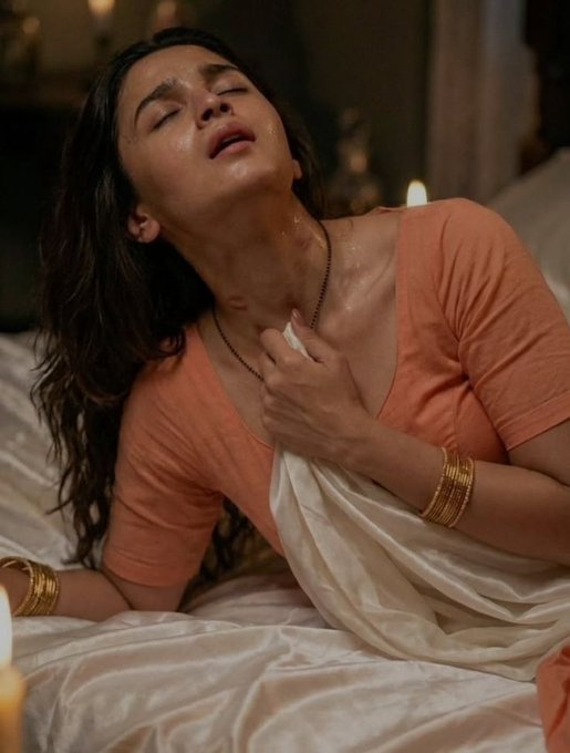 Alia Bhatt  {   "prompt": "A cinematic, ultra-realistic portrait of a young Indian woman reclining on a bed in a soft...