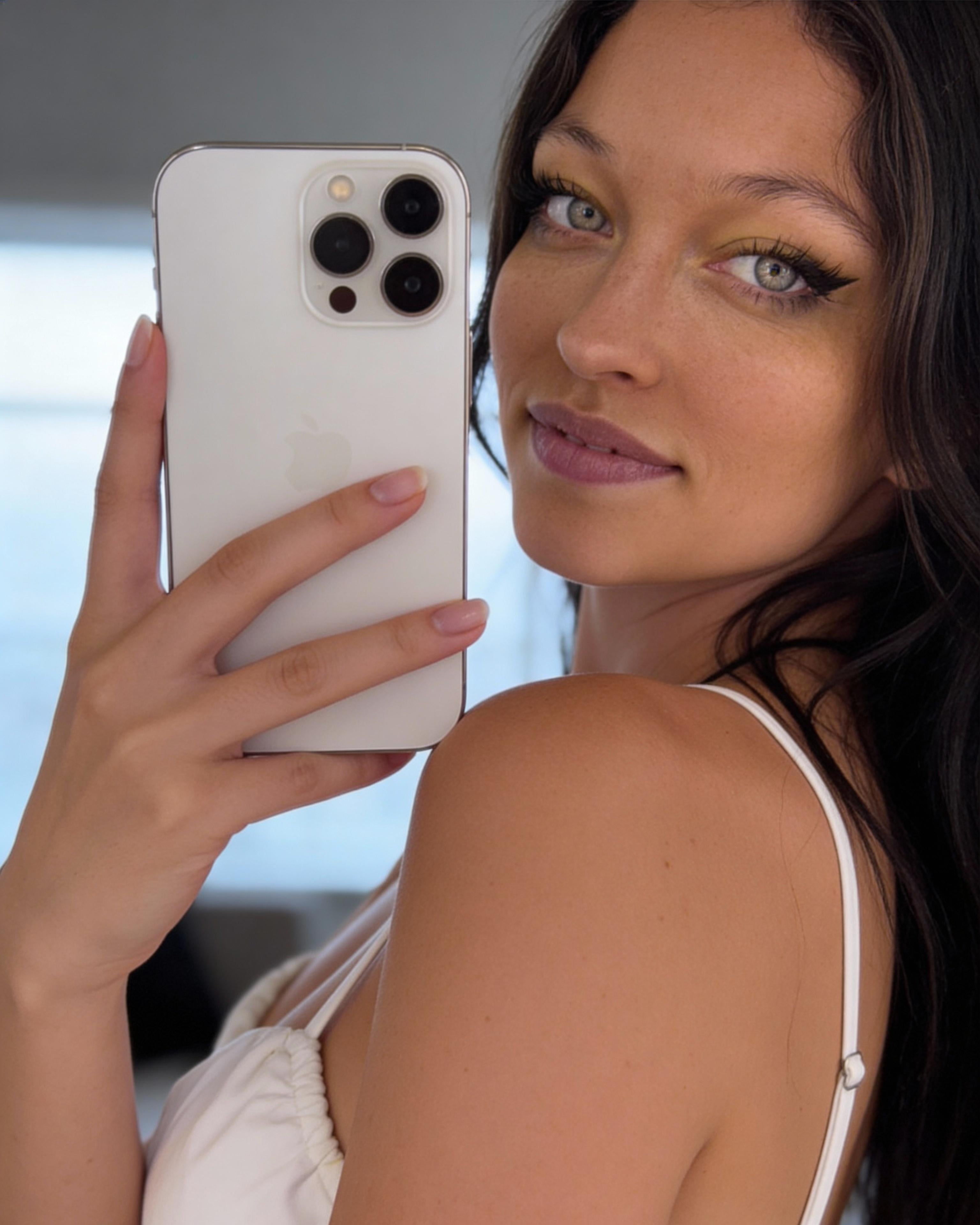 Selfie With White Iphone 14 Pro Looking Over Shoulder reference photo