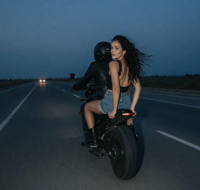 Two People On Moving Motorcycle Cinematic Dusk